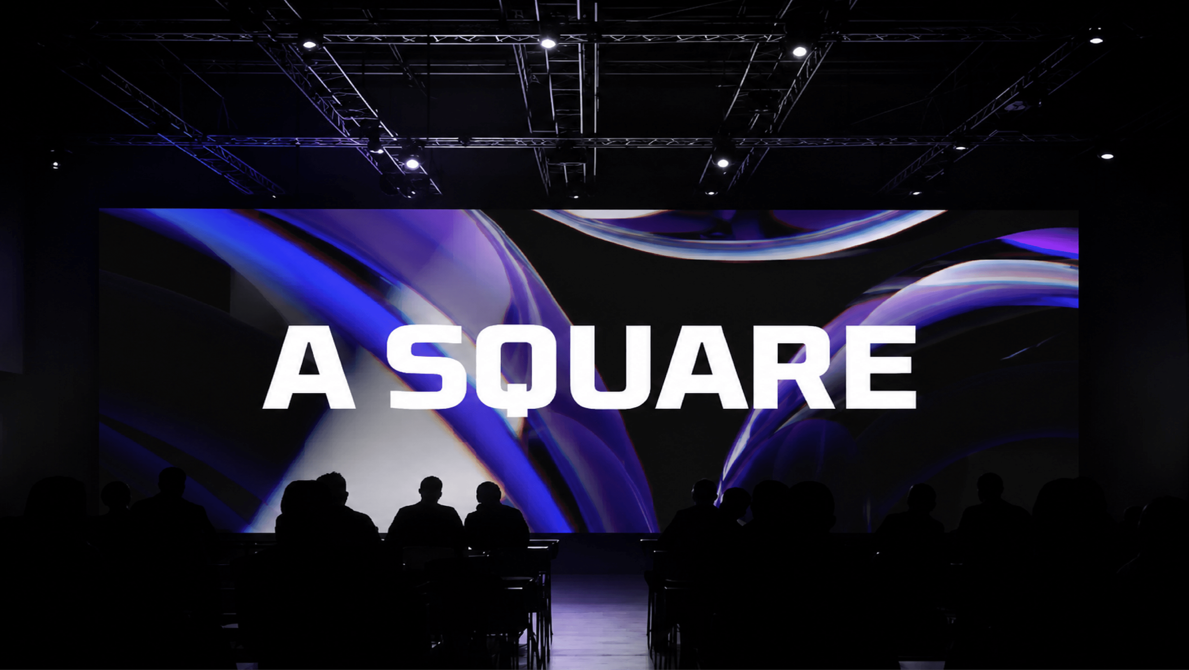 A Square wordmark projected on a cinema screen in front of an audience